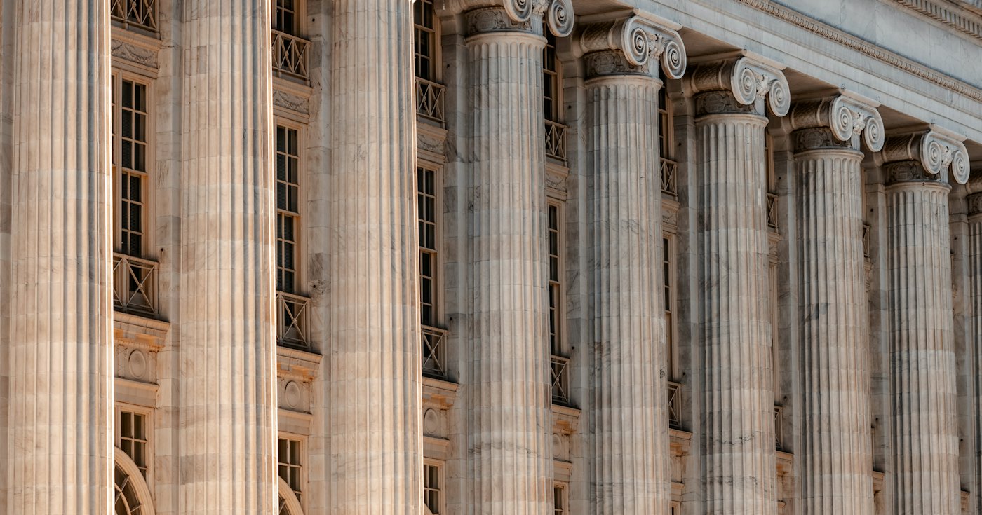 Courthouse building with columns and a clock