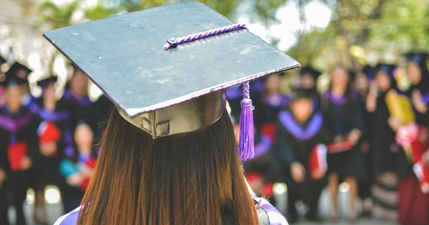 A graduate in an academic cap and gown