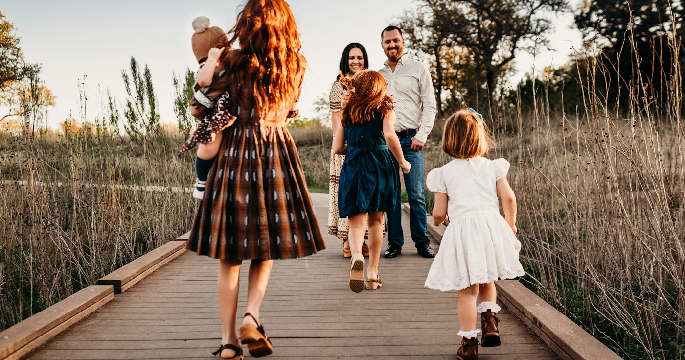A family walking together along a boardwalk